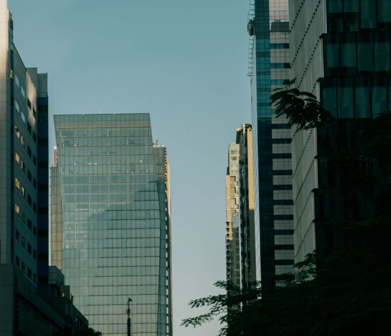 Modern glass office towers in a city business district, evoking the Nairobi skyline that will host Africa Global PR Week 2026