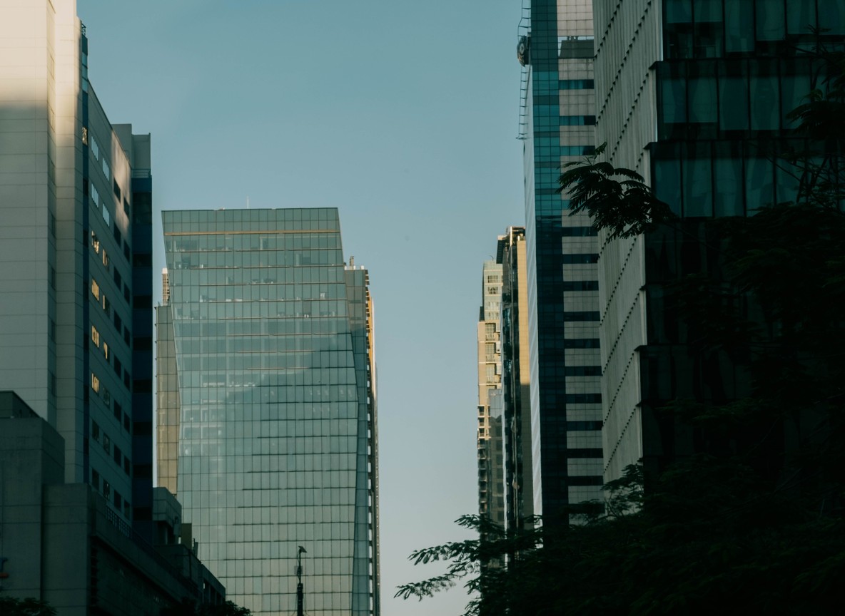 Modern glass office towers in a city business district, evoking the Nairobi skyline that will host Africa Global PR Week 2026