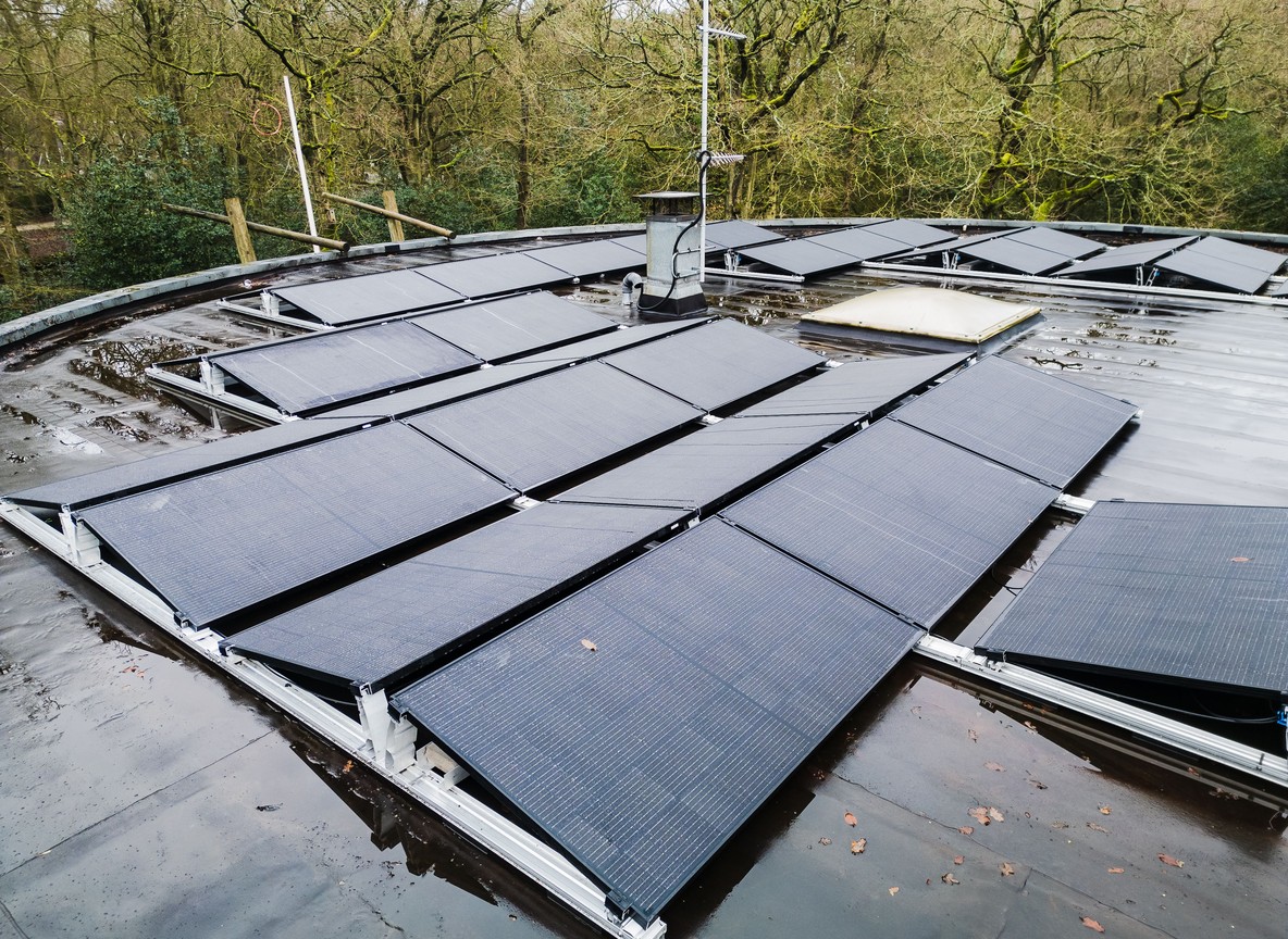 Solar panels mounted on a camp rooftop generating power off-grid