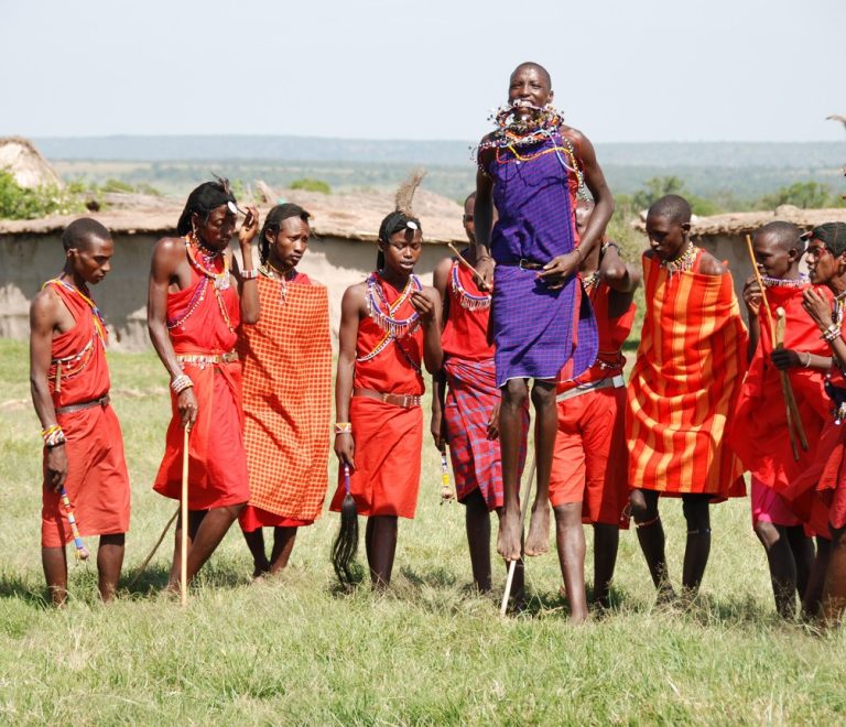 Maasai warriors in traditional red shuka and beaded ornaments gathered for a cultural ceremony in Kenya