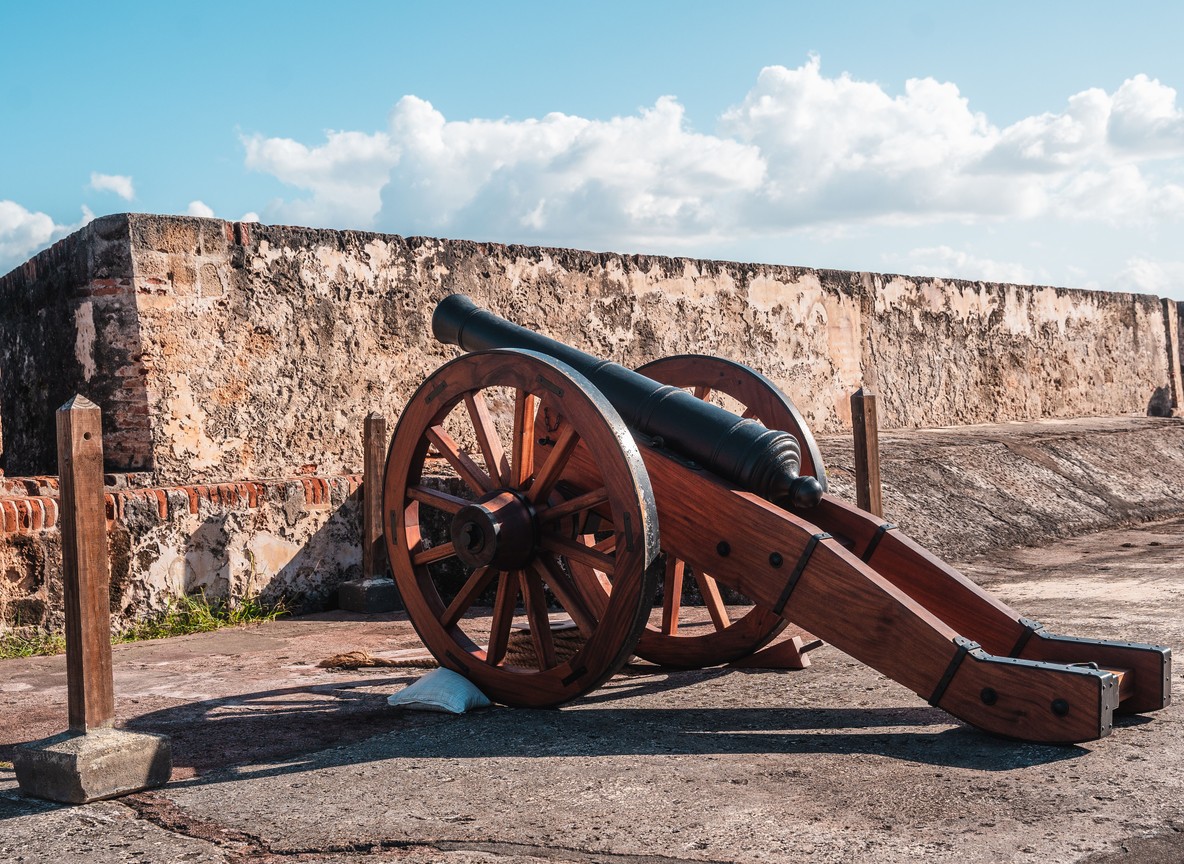 a historic cannon on a coastal fort battlement, evoking Kenya's Swahili coast heritage sites like Fort Jesus