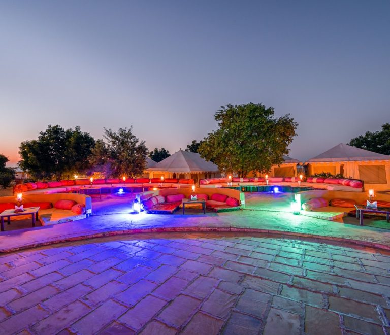 An exclusive-use luxury villa deck overlooking the Maasai Mara plains at sunset
