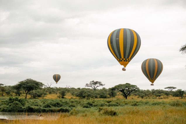 Hot air balloon drifting over the African savanna