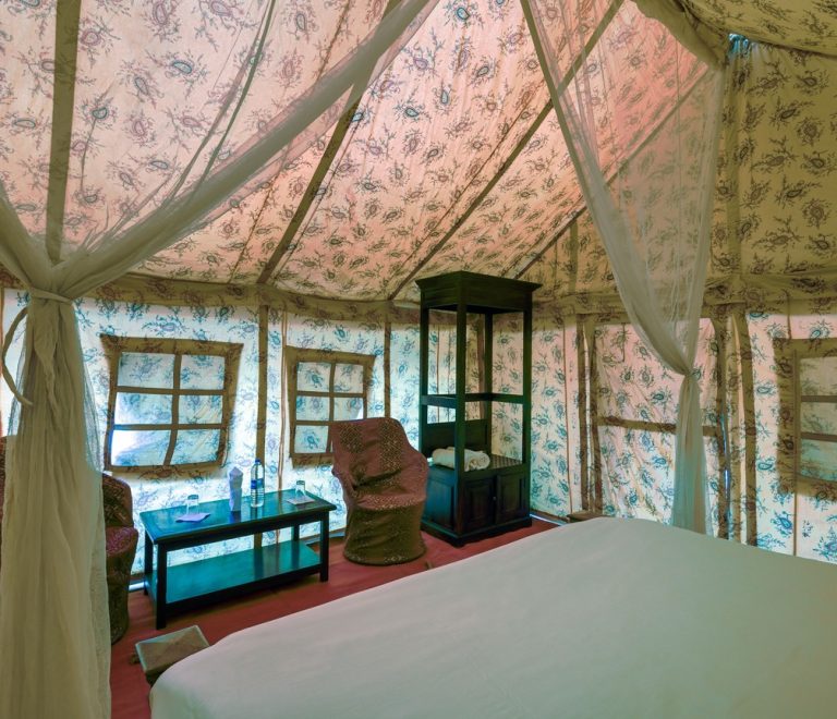 the canopied interior of a luxury safari tented suite, the style of accommodation at Sasaab and Solio Lodge
