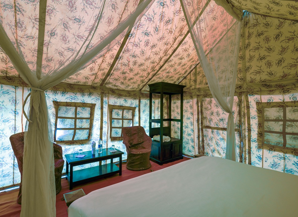 the canopied interior of a luxury safari tented suite, the style of accommodation at Sasaab and Solio Lodge